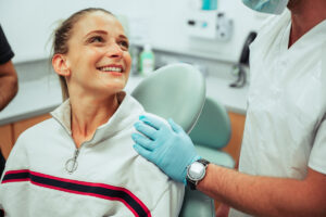 Caucasian female teenager smiling while at annual dentist checkup