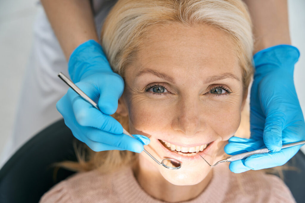Close-up of beautiful patient is having teeth examined by dentist in clinic