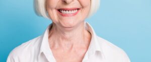 Senior woman smiling with healthy teeth and dental implants